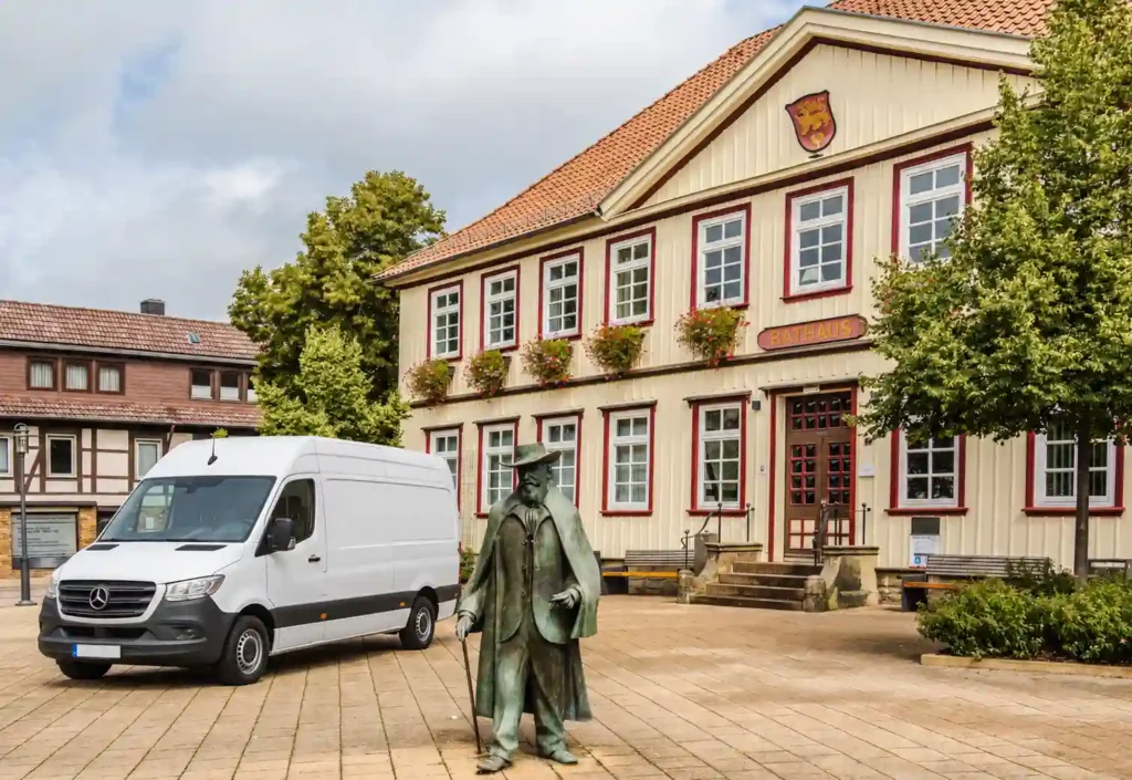 Weißer Transporter für Entrümpelung vor dem Rathaus und Denkmal in Seesen